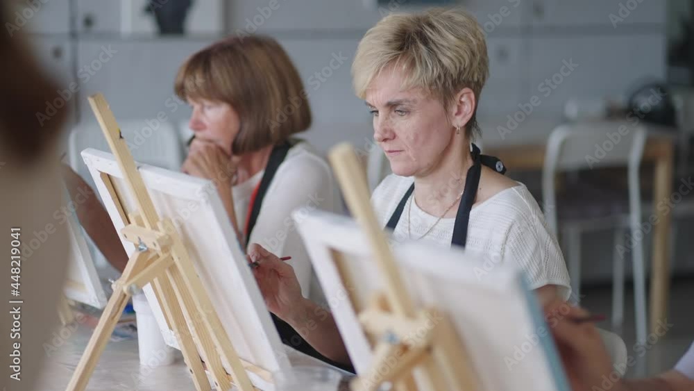 Like senior friends attending together at a painting class. small group taking a variety of fun classes together. A group of elderly people attend a master class on drawing together spending time. Like senior friends attending together at a painting class. small group taking a variety of fun classes together. A group of elderly people attend a master class on drawing together spending time.
