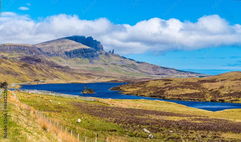 A view down Loch Leathan with the Old Man of Storr rock formation visible in the distance on the Isle of Skye, Scotland on a summers day