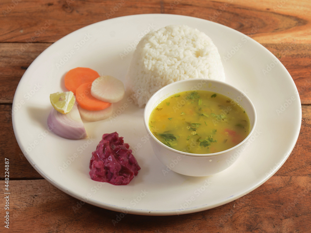 Veg Dal rice combo, made of chana dal, Dalcha served over a rustic wooden table. selective focus Veg Dal rice combo, made of chana dal, Dalcha served over a rustic wooden table. selective focus