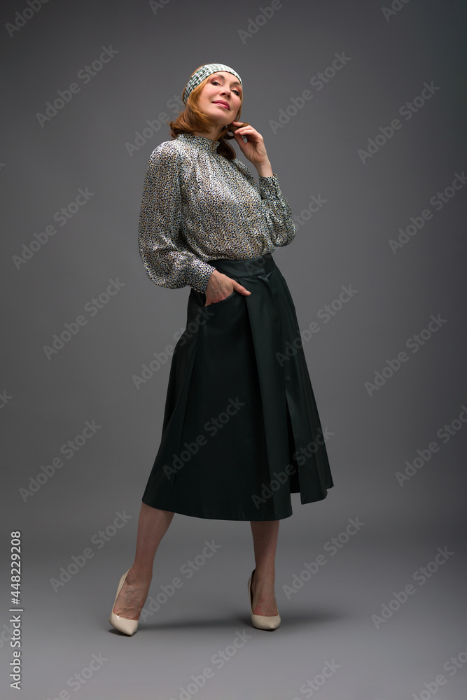 full length portrait of a fashionable aged woman isolated on grey full length portrait of a fashionable aged woman isolated on grey