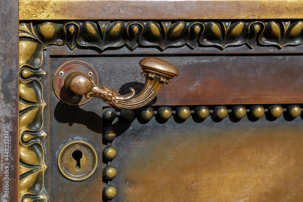 Bronze handle and keyhole on a metal door