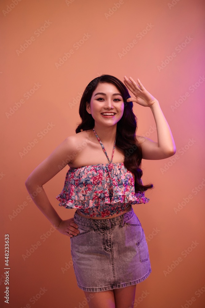 A pretty positive woman with fashion, glitter makeup isolated over mixer neon background A pretty positive woman with fashion, glitter makeup isolated over mixer neon background