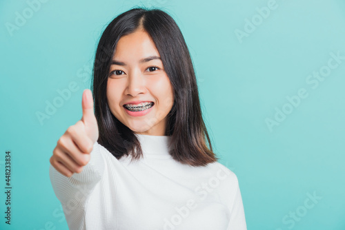 Valokuva Young beautiful Asian woman cheerful smiling showing finger thumb up, Portrait h