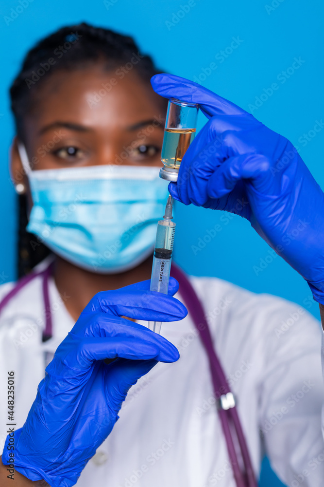 medicine, vaccination and healthcare concept - african american female doctor or scientist in mask with syringe medicine, vaccination and healthcare concept - african american female doctor or scientist in mask with syringe