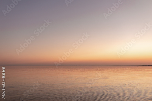 Fototapeta Naklejka Na Ścianę i Meble -  sunset sun by the ocean, clear water and sandy azure beach