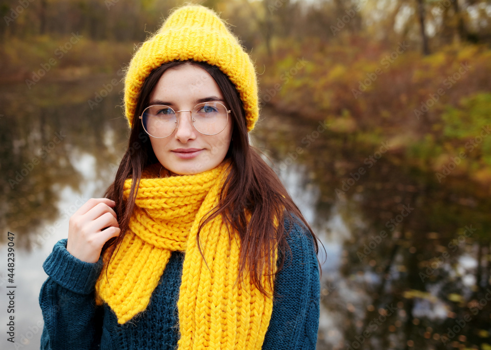 Portrait of a funny young girl in the autumn weather in warm clothes and hat. Portrait of a funny young girl in the autumn weather in warm clothes and hat.