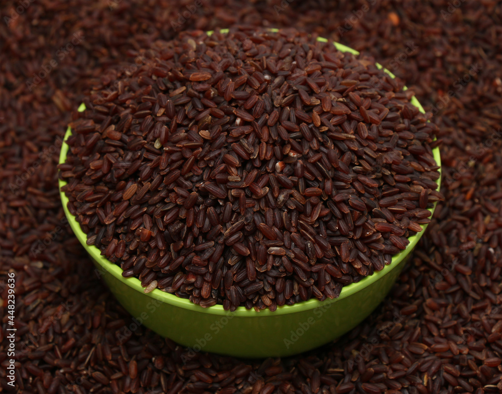 Brown or purple long rice background, uncooked raw cereals