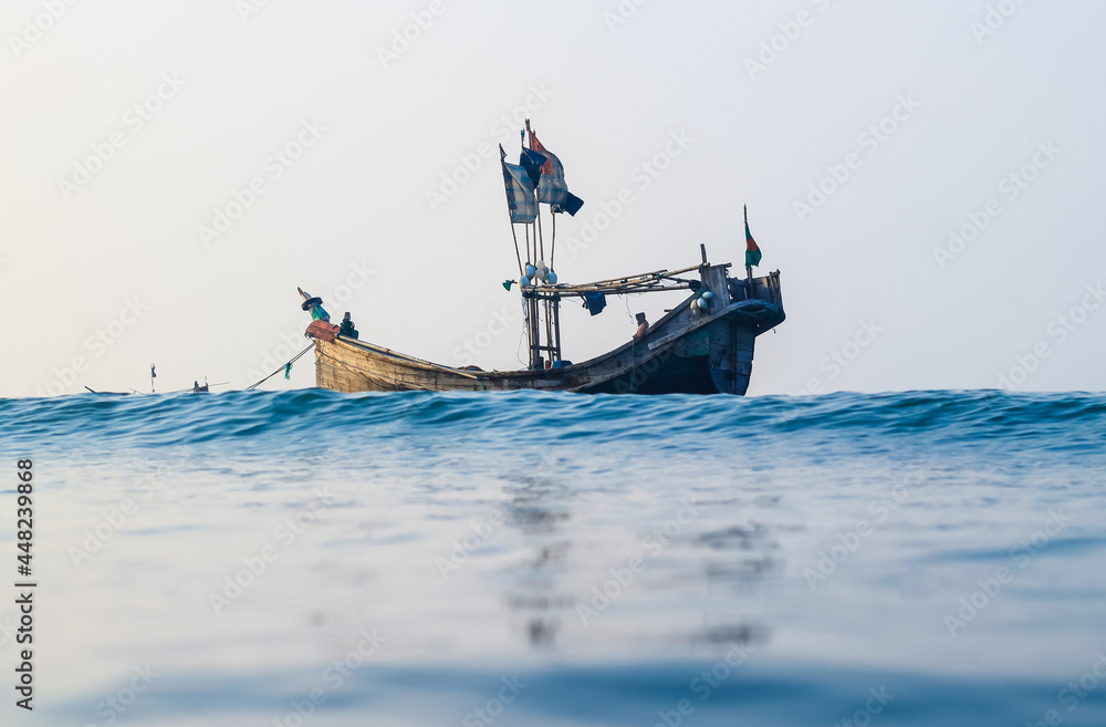 Naklejka premium Photo of Industrial fishing boat. Fishing boat in the sea. The fishing industry in Bangladesh. Bangladeshi traditional fishing boat on St. Martin's Island.