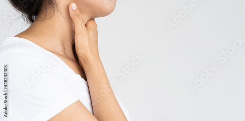 Young woman with sore throat holding hands, medical concept
