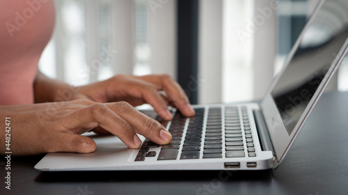 Hands typing keyboard on laptop, internet working concept.