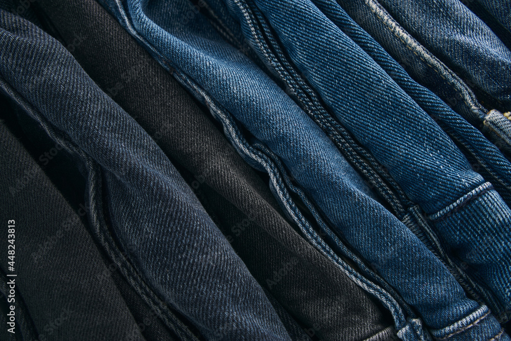 Stack of Various Shades Of Blue Jeans On White Background Denim jeans texture. Denim background texture for design. Canvas denim texture. Blue denim that can be used as background. Stack of Various Shades Of Blue Jeans On White Background Denim jeans texture. Denim background texture for design. Canvas denim texture. Blue denim that can be used as background.