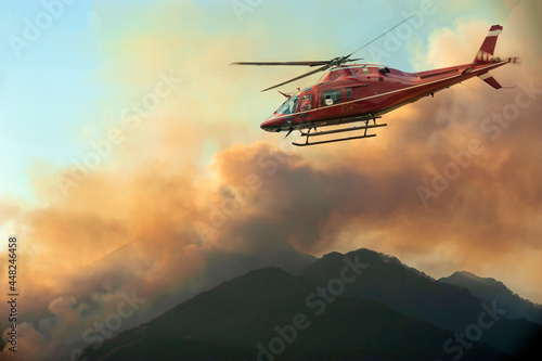 Firefighters helicopter monitor the fire in the mountain
