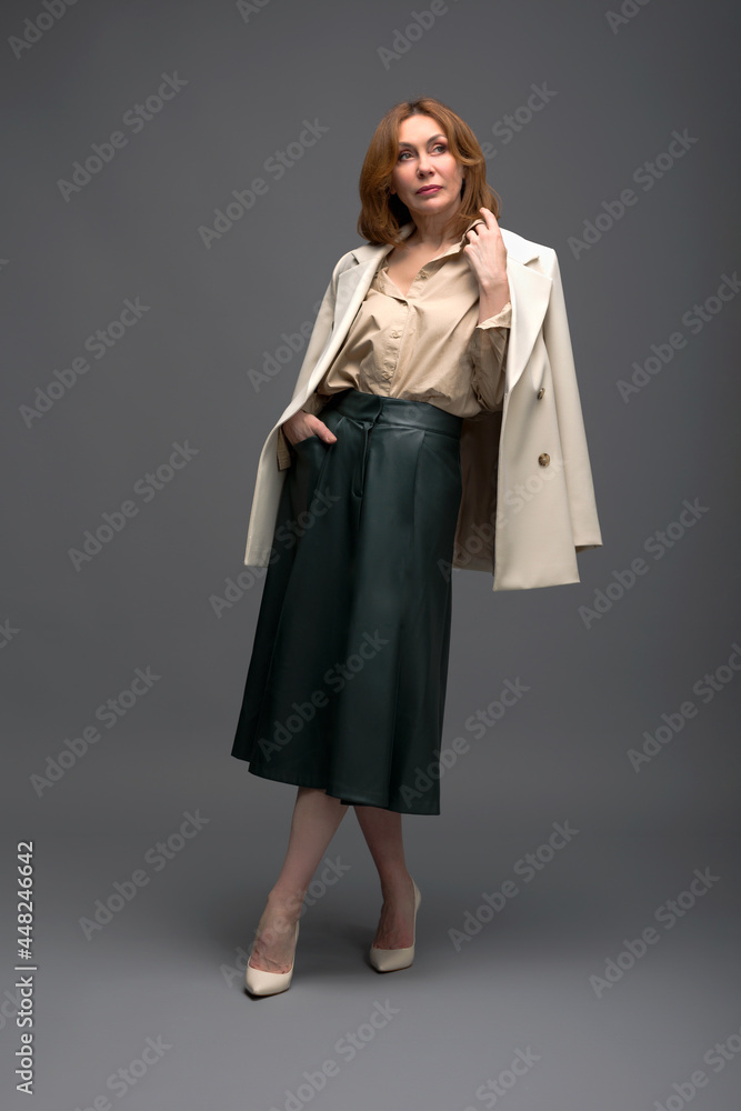 full length portrait of a fashionable aged woman isolated on grey full length portrait of a fashionable aged woman isolated on grey
