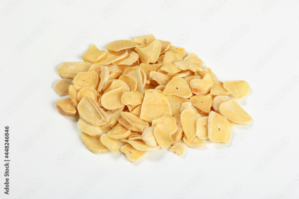 Dried garlic flakes on white background. Dried vegetables Dried garlic flakes on white background. Dried vegetables