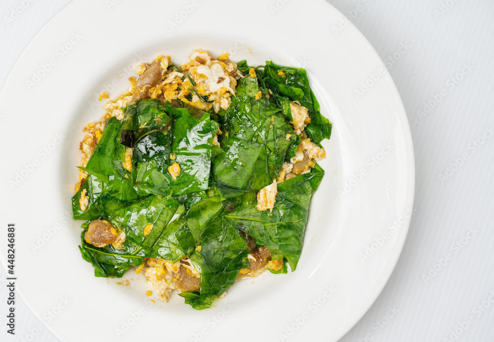 Stir-fried Malindjo leaves with egg; (Bai Lieng Pad Kai) is a famous local food in Southern Thailand. Stir-fried Malindjo leaves with egg; (Bai Lieng Pad Kai) is a famous local food in Southern Thailand.