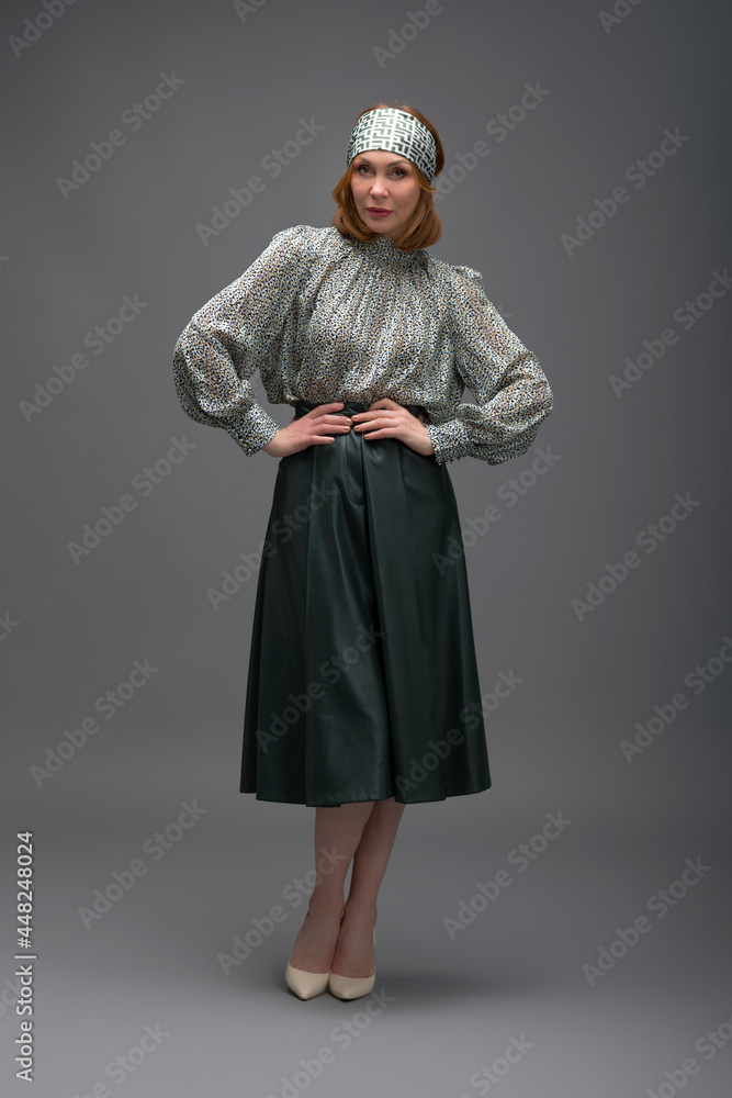 full length portrait of a fashionable aged woman isolated on grey full length portrait of a fashionable aged woman isolated on grey