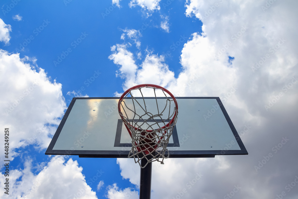 Basketball board, seen from below, on cloudy sky Basketball board, seen from below, on cloudy sky