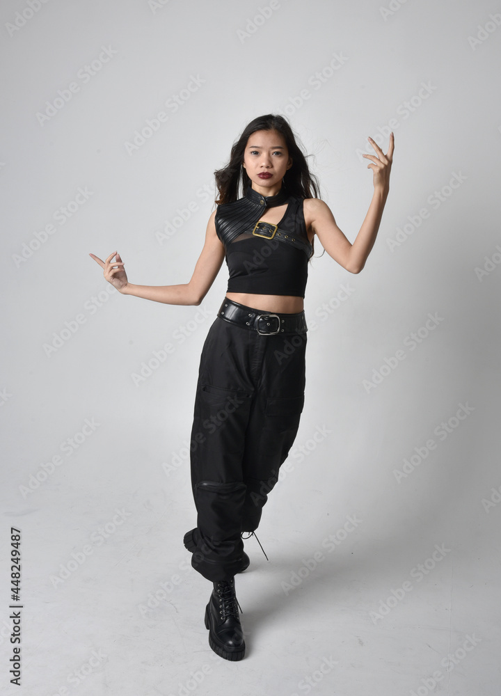 Full length portrait of pretty young asian girl wearing black tank top ...
