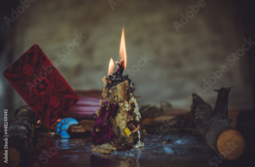 Candle burns on the altar, magic among candles, clean negative energy, wicca concept photo