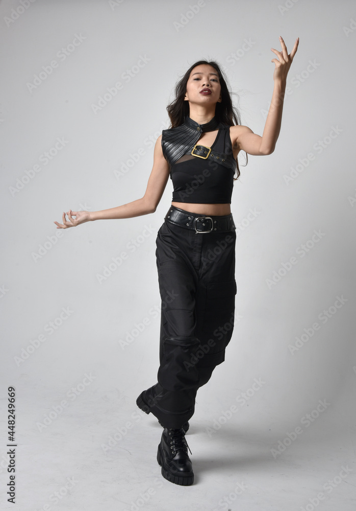 Full length portrait of pretty young asian girl wearing black tank top ...