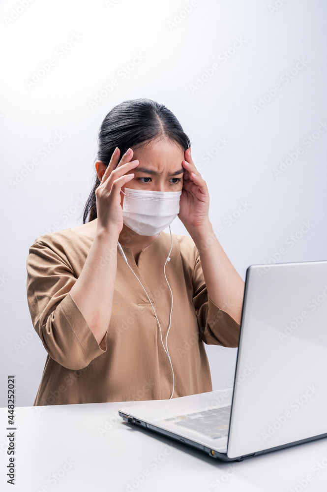 Asian woman wears protective mask and worry about Coronavirus on her working day on white background Asian woman wears protective mask and worry about Coronavirus on her working day on white background