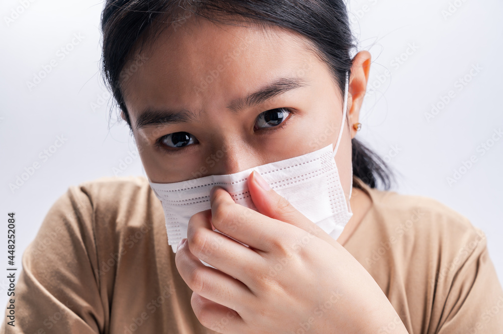 Asian woman is wearing sanitary gloves, mask on her face against coronavirus or COVID-19 disease. The Pollution Healthcare and virus pandemic concept. Asian woman is wearing sanitary gloves, mask on her face against coronavirus or COVID-19 disease. The Pollution Healthcare and virus pandemic concept.
