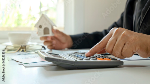 Fototapeta Naklejka Na Ścianę i Meble -  Close-up of a businessman using a calculator and checking accounting reports concept of work finance investment