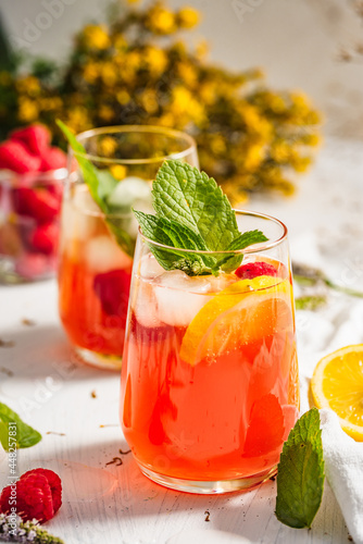 Cold drink. Orange drink with mint and fruits. Fresh drink in glass. Summer drink. Drink from beach bar.