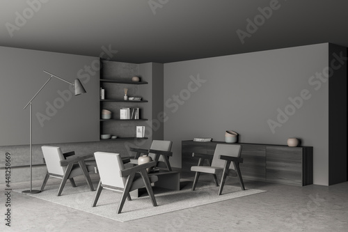 Dark grey-hued living room with armchairs and slim lamp