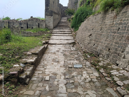 Stairs of the famous Kangra Fort historical landmark in Kangra, India on a gloomy day photo