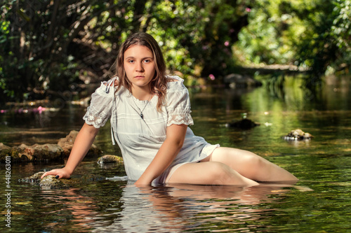 woman with white dress near stream of water