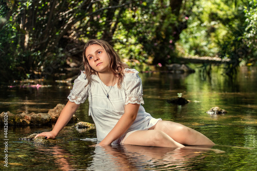 woman with white dress near stream of water