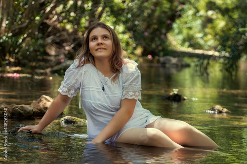 woman with white dress near stream of water