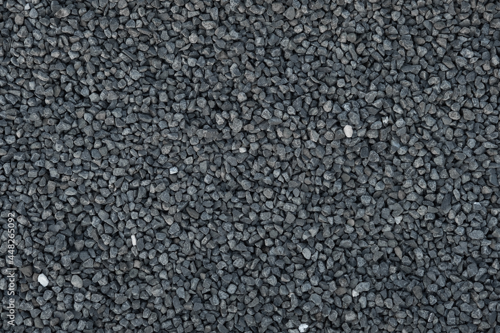 Close-up of crushed stone, granite gravel. Rough geometric seamless pattern and background of building material. Close-up of crushed stone, granite gravel. Rough geometric seamless pattern and background of building material.