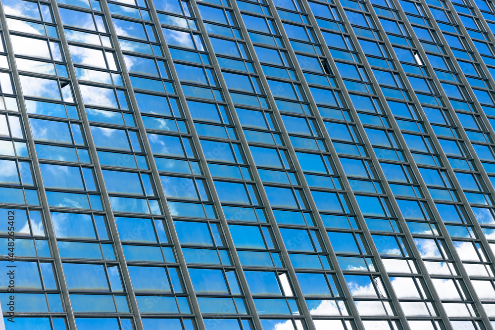 Blue office windows. Windows with a reflection of the sky in a large building
