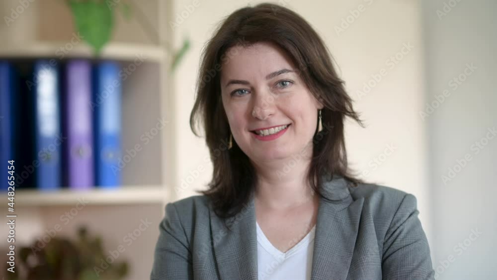 Beautiful smiling middle aged adult business woman looking at camera stand in office. Happy confident lady, attractive senior female professional coach. Beautiful smiling middle aged adult business woman looking at camera stand in office. Happy confident lady, attractive senior female professional coach.