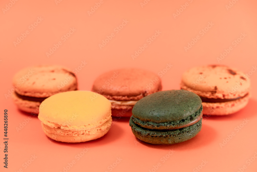 Fototapeta premium Close up of macaroons on an orange background