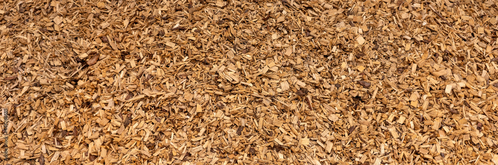 Panoramic background. Bark mulch, brown wood chips Panoramic background. Bark mulch, brown wood chips