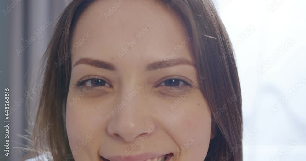 Close up shot of Caucasian female face looking at camera and smiling in good mood. Cheerful beautiful woman looks at camera with smile on face. Positive emotions, leisure, happy face Close up shot of Caucasian female face looking at camera and smiling in good mood. Cheerful beautiful woman looks at camera with smile on face. Positive emotions, leisure, happy face