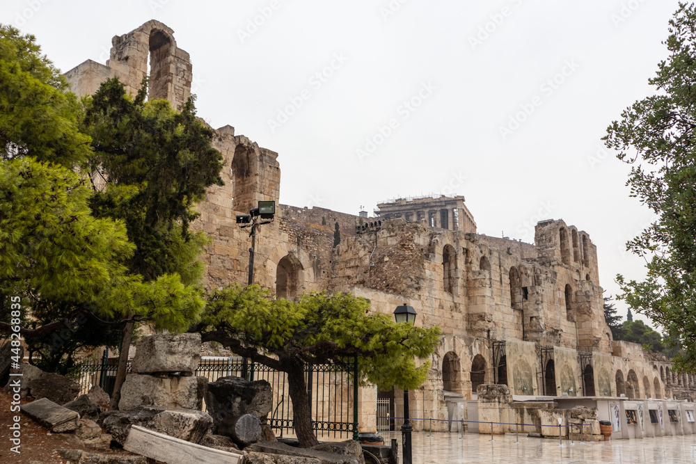 Entrance square to Odeon of Herodes Atticus in green pine trees on hills of Acropolis, Athens, Greece