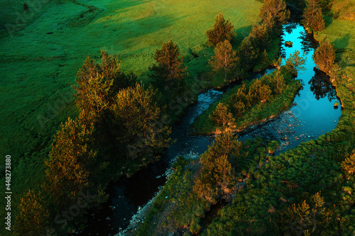 Aerial view of mountain creek winding through beautiful grassy landscape on Zlatibor, Serbia