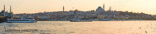 Tourist boat sails on the Golden Horn in Istanbul at sunset, Turkey. © sarymsakov.com