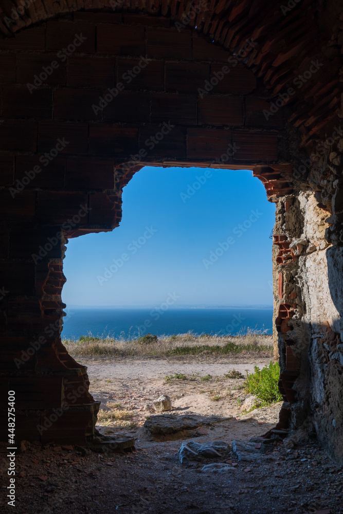 ocean view from a hole in a brick wall