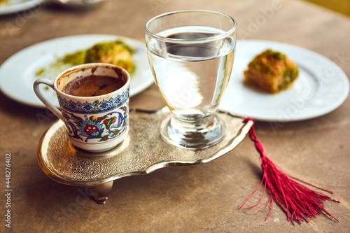Turkish coffee and turkish delight with traditional embossed metal tray and cup photo