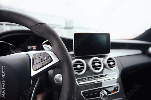 Control buttons on steering wheel. Car interior.