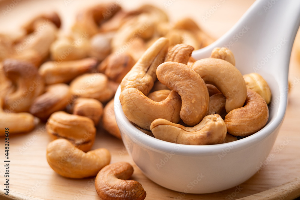 Roasted cashew nuts in white bowl,Healthy snack Delicacies food. Roasted cashew nuts in white bowl,Healthy snack Delicacies food.