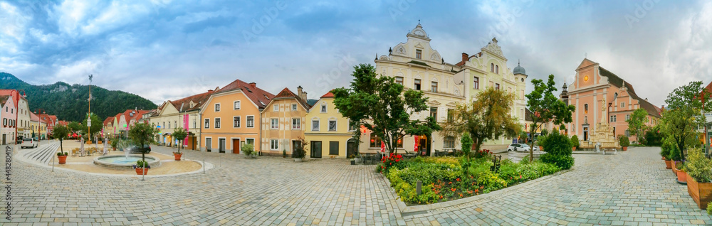 The main square with old buildings and Parish Church in the charming little town of Frohnleiten in the district of Graz-Umgebung, Styria region, Austria