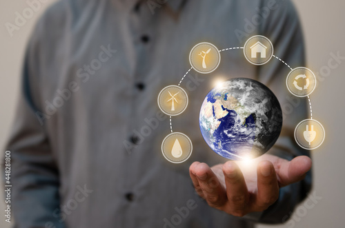 Close up man holding planet Earth as a green and dry.Renewable energy efficency and Environmental biodiversity concept.Elements of this image furnished by NASA