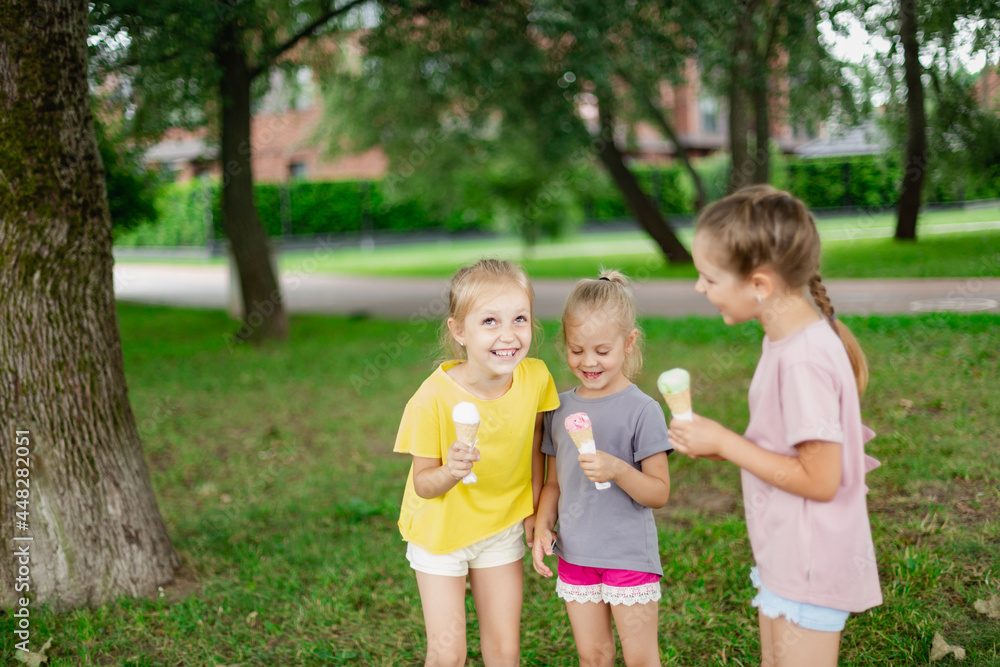 Kids enjoying ice cream treats outside and laughing. Summer fun concept Kids enjoying ice cream treats outside and laughing. Summer fun concept
