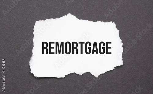 remortgage sign on the torn paper on the black background photo